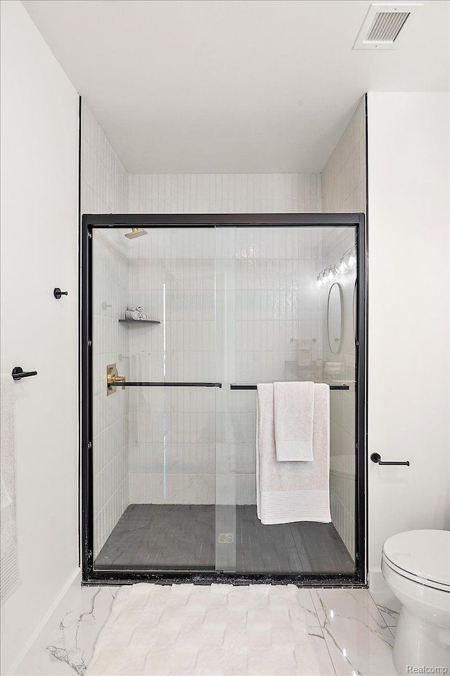 330 Gratiot Ave Unit 1504, Detroit, MI 48226 - bathroom featuring marble look tiles and a shower stall