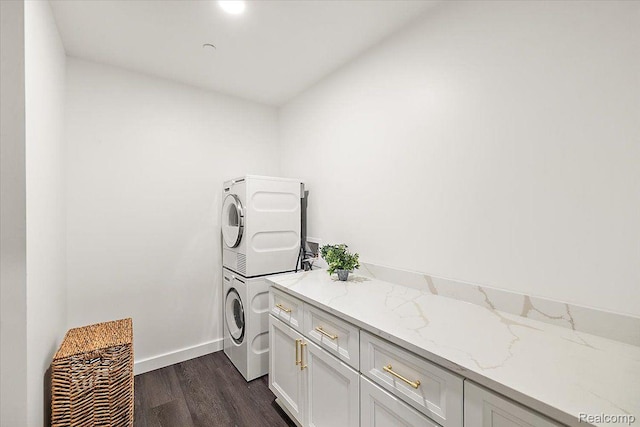330 Gratiot Ave Unit 1504, Detroit, MI 48226 - washroom featuring stacked washer / drying machine, cabinet space, and dark wood-type flooring