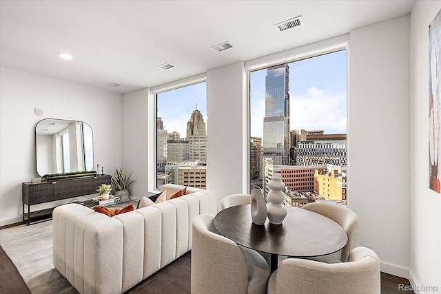 330 Gratiot Ave Unit 1504, Detroit, MI 48226 - living room with a skyline view, wood finished floors, and floor to ceiling windows