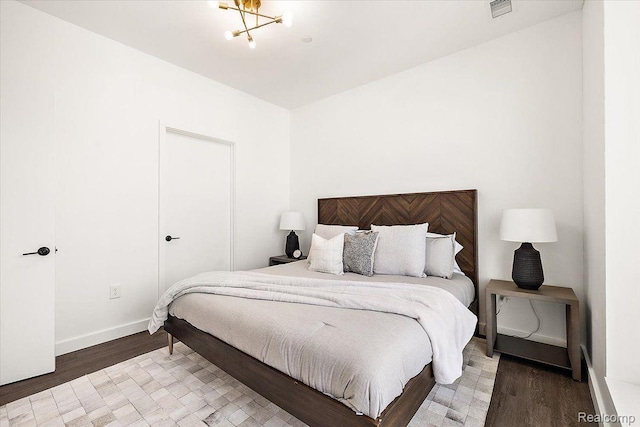330 Gratiot Ave Unit 1504, Detroit, MI 48226 - bedroom featuring light wood-style floors and a chandelier