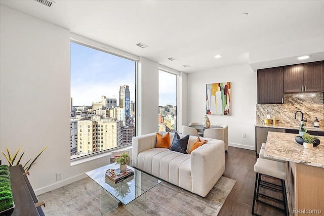330 Gratiot Ave Unit 1504, Detroit, MI 48226 - living room with dark wood-type flooring, a city view, and recessed lighting