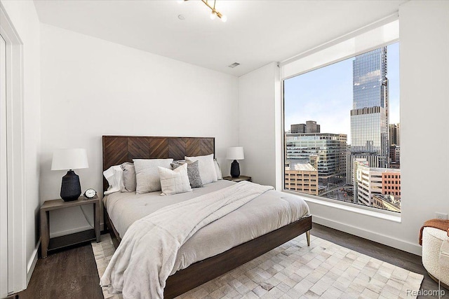 330 Gratiot Ave Unit 1504, Detroit, MI 48226 - bedroom with wood finished floors and a city view
