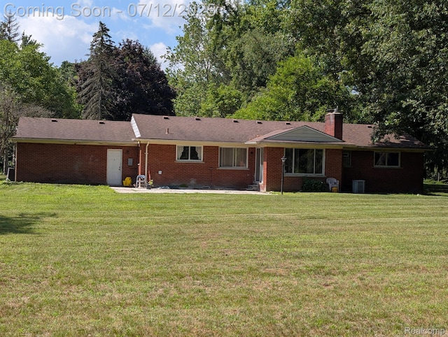 22048 Rougewood Dr, Southfield, MI 48033 - rear view of property with a lawn, brick siding, a chimney, and a patio area