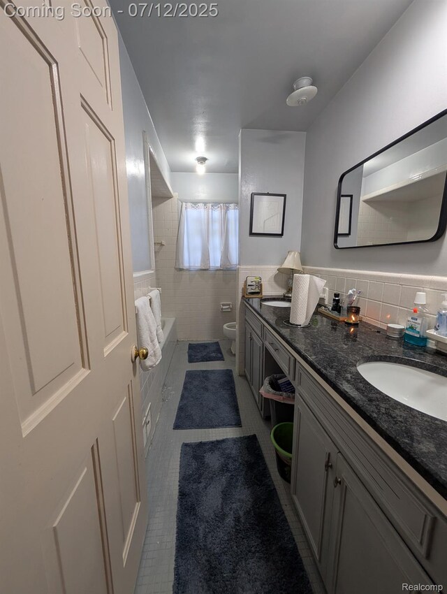 22048 Rougewood Dr, Southfield, MI 48033 - bathroom with vanity, tile patterned flooring, tile walls, shower / tub combination, and a wainscoted wall
