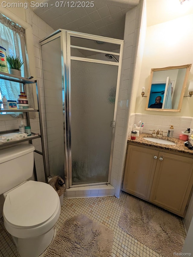 22048 Rougewood Dr, Southfield, MI 48033 - full bathroom with vanity, a shower stall, tile patterned flooring, tile walls, and wainscoting