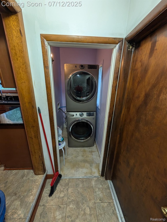 22048 Rougewood Dr, Southfield, MI 48033 - laundry room featuring stacked washer / drying machine and stone finish flooring