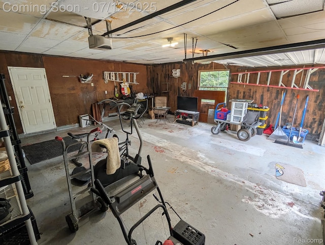 22048 Rougewood Dr, Southfield, MI 48033 - garage featuring a garage door opener and wooden walls