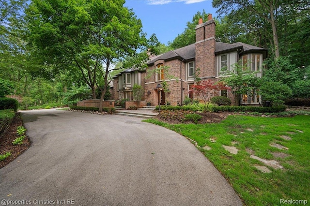 347 Pine Ridge Dr, Bloomfield Hills, MI 48304 - english style home featuring driveway, a chimney, and brick siding