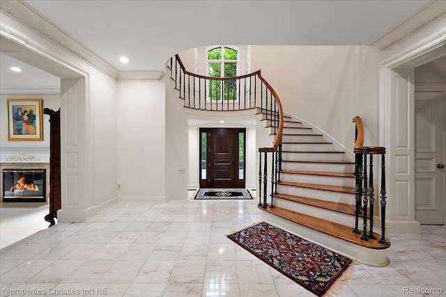 347 Pine Ridge Dr, Bloomfield Hills, MI 48304 - foyer with marble tiled floors, stairway, ornamental molding, a glass covered fireplace, and recessed lighting