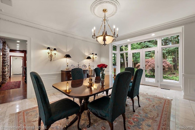 347 Pine Ridge Dr, Bloomfield Hills, MI 48304 - dining space featuring a chandelier, french doors, crown molding, wainscoting, and light tile patterned floors