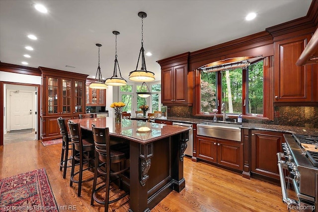 347 Pine Ridge Dr, Bloomfield Hills, MI 48304 - kitchen featuring stove, dishwasher, a breakfast bar, tasteful backsplash, and hanging light fixtures