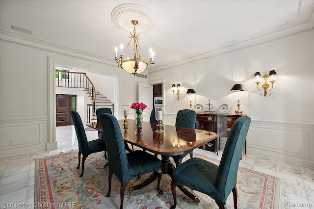 347 Pine Ridge Dr, Bloomfield Hills, MI 48304 - dining area featuring stairs, a chandelier, light marble finish floors, crown molding, and wainscoting
