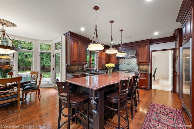 347 Pine Ridge Dr, Bloomfield Hills, MI 48304 - kitchen with extractor fan, tasteful backsplash, a kitchen island, a kitchen breakfast bar, and recessed lighting