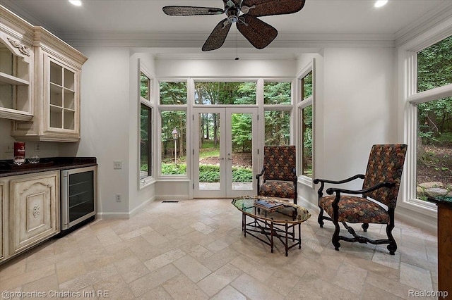 347 Pine Ridge Dr, Bloomfield Hills, MI 48304 - living area featuring beverage cooler, stone tile floors, a dry bar, ornamental molding, and french doors