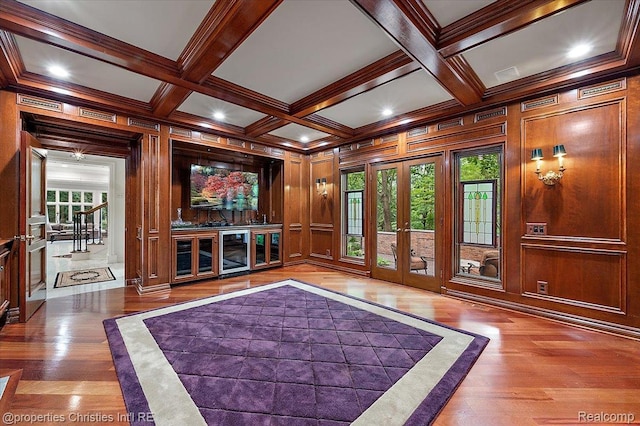 347 Pine Ridge Dr, Bloomfield Hills, MI 48304 - home theater room with french doors, beverage cooler, beamed ceiling, plenty of natural light, and wood finished floors
