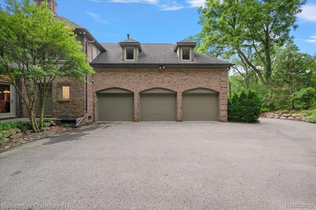 347 Pine Ridge Dr, Bloomfield Hills, MI 48304 - view of front of property featuring driveway, brick siding, and an attached garage