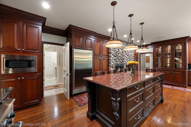347 Pine Ridge Dr, Bloomfield Hills, MI 48304 - kitchen featuring built in appliances, dark wood finished floors, hanging light fixtures, a kitchen island, and glass insert cabinets