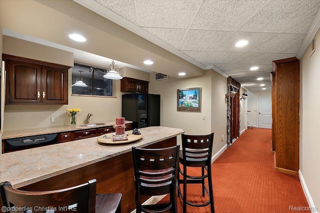 347 Pine Ridge Dr, Bloomfield Hills, MI 48304 - kitchen with freestanding refrigerator, recessed lighting, carpet flooring, dishwasher, and a breakfast bar area