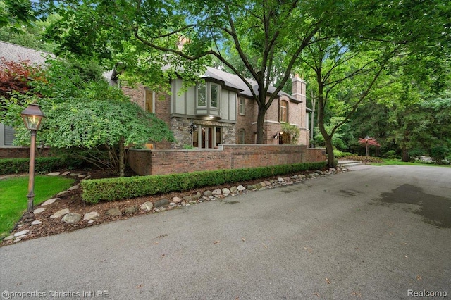 347 Pine Ridge Dr, Bloomfield Hills, MI 48304 - view of front of home featuring a chimney and stone siding
