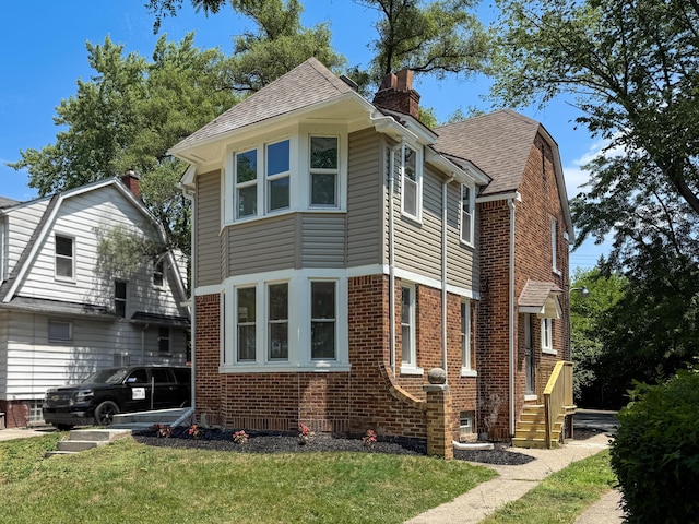 15786 Rutherford St, Detroit, MI 48227 - view of home's exterior featuring brick siding, a chimney, a lawn, and roof with shingles