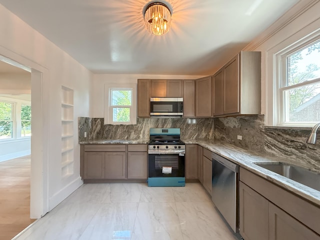 15786 Rutherford St, Detroit, MI 48227 - kitchen featuring stainless steel appliances, backsplash, and light stone counters