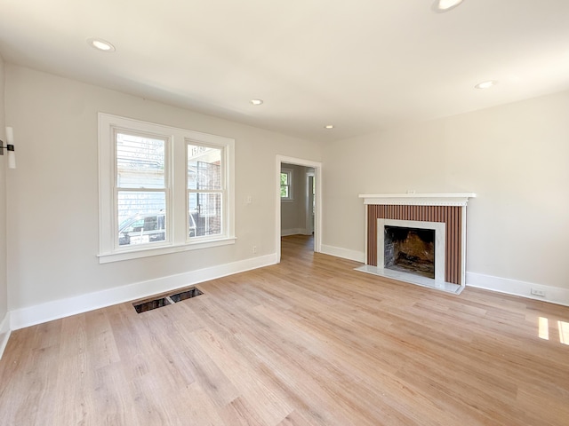 15786 Rutherford St, Detroit, MI 48227 - unfurnished living room featuring a fireplace with flush hearth, light wood-style floors, and recessed lighting