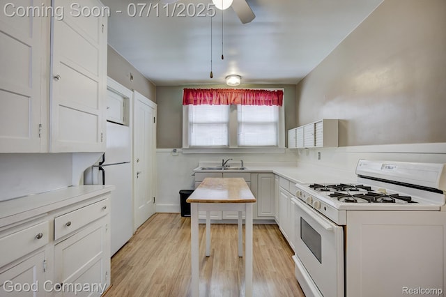 515 W Golden Gate, Detroit, MI 48203 - kitchen featuring white appliances, light wood finished floors, white cabinets, and light countertops