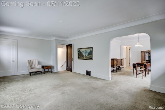 515 W Golden Gate, Detroit, MI 48203 - living area with arched walkways, carpet floors, a chandelier, and ornamental molding