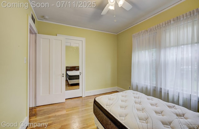 515 W Golden Gate, Detroit, MI 48203 - bedroom with light wood-type flooring, ornamental molding, multiple windows, and ceiling fan