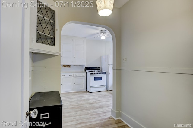 515 W Golden Gate, Detroit, MI 48203 - kitchen with white appliances, white cabinets, light wood finished floors, glass insert cabinets, and a ceiling fan