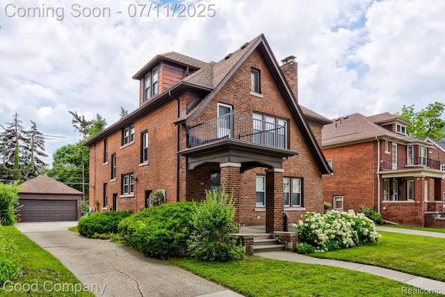 515 W Golden Gate, Detroit, MI 48203 - english style home featuring a balcony, brick siding, a chimney, a garage, and a front lawn