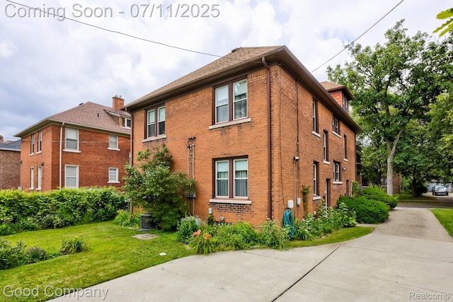 515 W Golden Gate, Detroit, MI 48203 - view of property exterior featuring brick siding and a yard