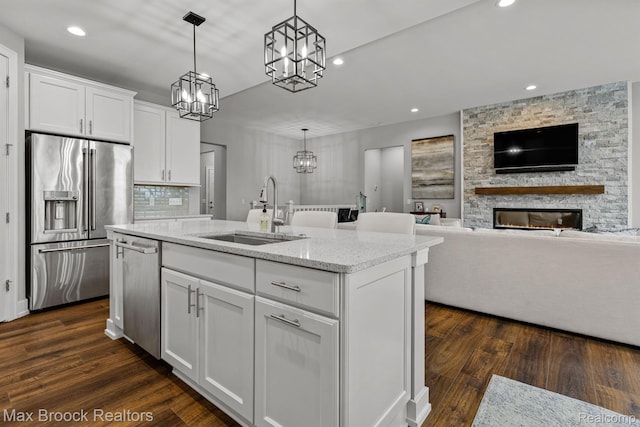 17170 Garden Ridge Ln Unit 72, Northville, MI 48168 - kitchen featuring appliances with stainless steel finishes, a chandelier, recessed lighting, light stone countertops, and white cabinets