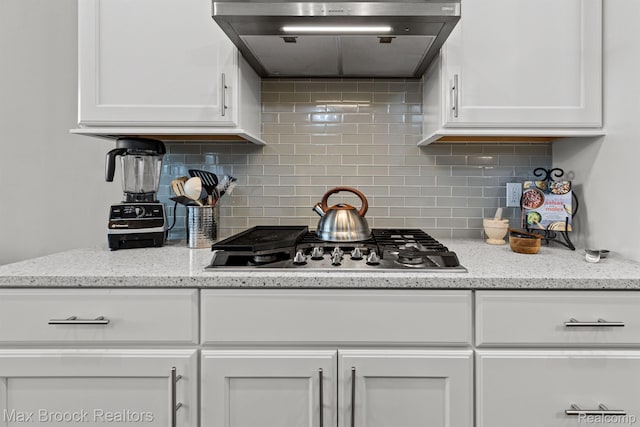 17170 Garden Ridge Ln Unit 72, Northville, MI 48168 - kitchen featuring ventilation hood, white cabinetry, and backsplash