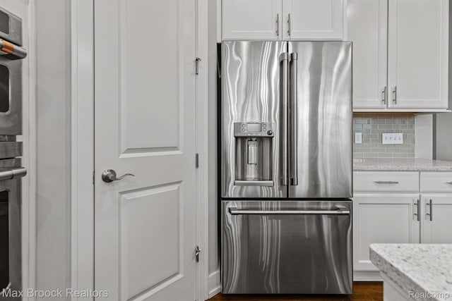 17170 Garden Ridge Ln Unit 72, Northville, MI 48168 - kitchen with stainless steel appliances, white cabinetry, backsplash, light stone counters, and dark wood-style flooring