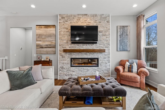 17170 Garden Ridge Ln Unit 72, Northville, MI 48168 - living area featuring wood finished floors, recessed lighting, and a stone fireplace