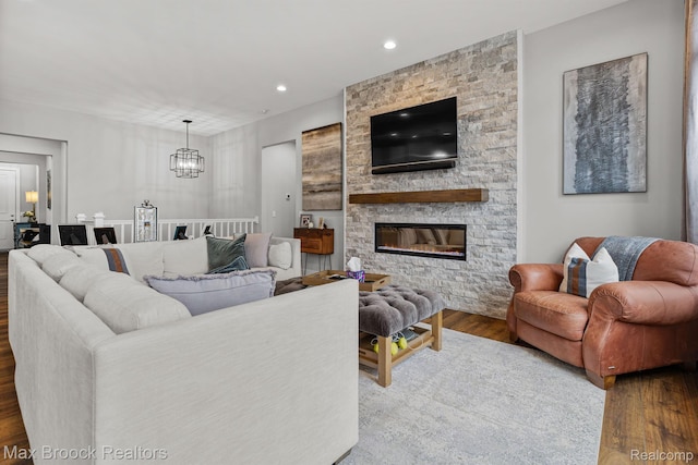 17170 Garden Ridge Ln Unit 72, Northville, MI 48168 - living area with wood finished floors, a chandelier, recessed lighting, and a stone fireplace