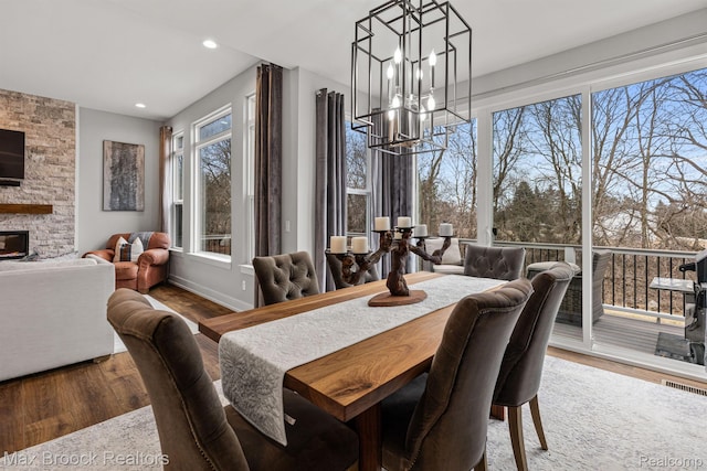 17170 Garden Ridge Ln Unit 72, Northville, MI 48168 - dining space with a chandelier, wood finished floors, recessed lighting, and a stone fireplace