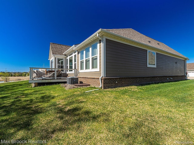 17170 Garden Ridge Ln Unit 72, Northville, MI 48168 - view of side of home featuring a deck, a lawn, and a shingled roof
