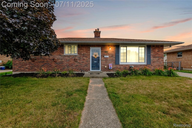 34019 Arrowhead St, Canton, MI 48185 - view of front of house featuring brick siding, a yard, and a chimney
