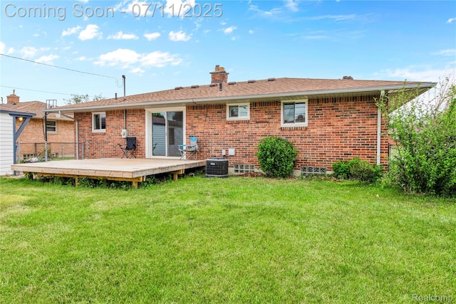 34019 Arrowhead St, Canton, MI 48185 - back of property with a deck, a lawn, brick siding, and a chimney