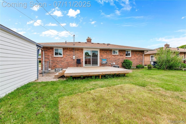 34019 Arrowhead St, Canton, MI 48185 - rear view of house featuring brick siding, a chimney, a yard, and a wooden deck