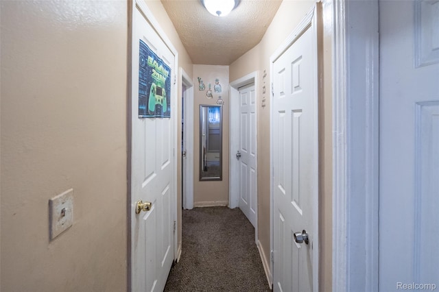 14599 Coyle St, Detroit, MI 48227 - corridor featuring dark carpet and a textured ceiling