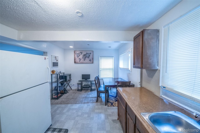 14599 Coyle St, Detroit, MI 48227 - kitchen with freestanding refrigerator, a textured ceiling, and light floors