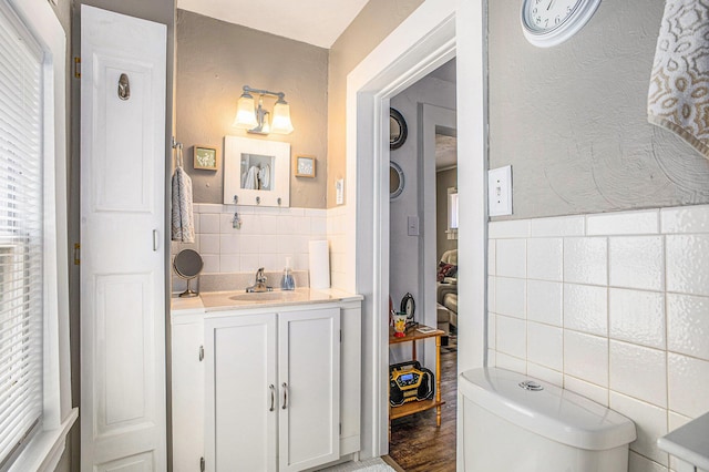 211 S 4th St, Niles, MI 49120 - bathroom with tile walls, vanity, and wainscoting