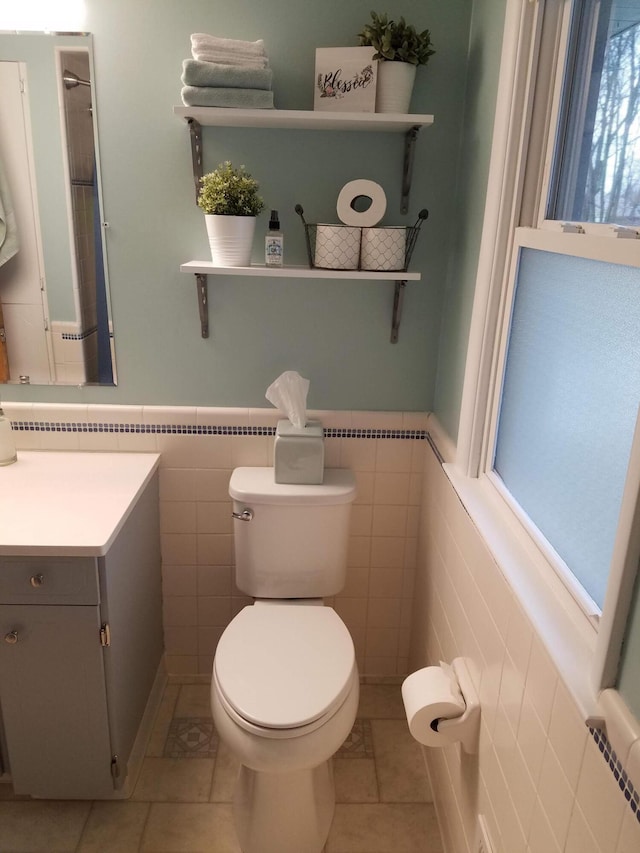 1200 Elmwood Dr, Jenison, MI 49428 - half bath featuring tile patterned flooring, vanity, a wainscoted wall, and tile walls