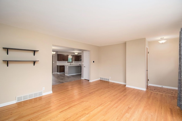 1200 Elmwood Dr, Jenison, MI 49428 - unfurnished living room with light wood-style flooring and baseboards