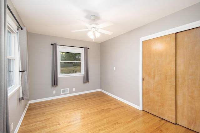 1200 Elmwood Dr, Jenison, MI 49428 - unfurnished bedroom with light wood-style floors, a closet, and ceiling fan