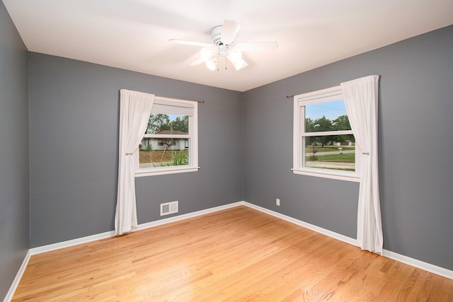 1200 Elmwood Dr, Jenison, MI 49428 - empty room with healthy amount of natural light, light wood-type flooring, and ceiling fan