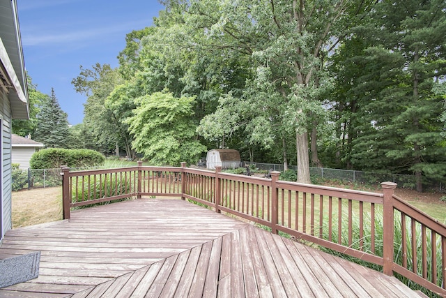 1200 Elmwood Dr, Jenison, MI 49428 - deck with a shed, a fenced backyard, and view of wooded area